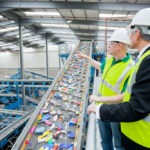 two men discussing conveyor belt safety practices