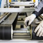 belt-tension Closeup of technician's hands as they adjust conveyor belt tension