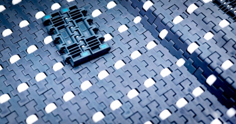 Texture of modular conveyor belt with roller. Conveyor equipment. Parts for machine in the factory. Use for move product in industrial. Belts conveyor perform well at incline or decline elevations.