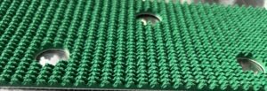 Green conveyor belt with perforations for airflow